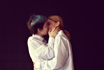 Two people sharing a tender, consensual moment together, representing queer love and LGBTQ intimacy